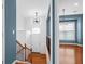 Inviting foyer with hardwood floors, a staircase, and a modern light fixture, seamlessly blending style and functionality at 4874 Seldon Se Way, Smyrna, GA 30080