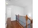 Upstairs hallway featuring hardwood floors and wrought iron spindles at 4874 Seldon Se Way, Smyrna, GA 30080