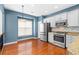 Bright kitchen with stainless steel appliances, including a refrigerator, oven, and granite countertops for meal preparation at 4874 Seldon Se Way, Smyrna, GA 30080