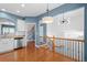Open concept kitchen with stainless steel appliances, white cabinetry, hardwood floors, and granite countertops at 4874 Seldon Se Way, Smyrna, GA 30080