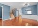 Inviting living room with hardwood floors, wainscoting detail, and modern light fixture at 4874 Seldon Se Way, Smyrna, GA 30080
