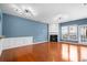 Bright and spacious living room featuring beautiful hardwood floors, a cozy fireplace, and stylish contemporary lighting at 4874 Seldon Se Way, Smyrna, GA 30080
