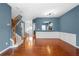Inviting living room with hardwood floors, wainscoting detail, and modern light fixture at 4874 Seldon Se Way, Smyrna, GA 30080