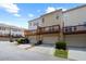 Exterior rear view of multi-level townhomes in a residential community featuring decks and garage doors at 4874 Seldon Se Way, Smyrna, GA 30080