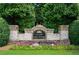 Community entrance sign featuring brick pillars, mature landscaping, and colorful flowerbeds, The Views at Park Avenue at 4874 Seldon Se Way, Smyrna, GA 30080