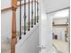 Carpeted staircase with wood handrail and decorative wrought iron spindles leading to an open storage area at 4874 Seldon Se Way, Smyrna, GA 30080