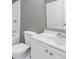 Well-lit bathroom featuring a toilet, shower and vanity with modern fixtures and cabinets at 504 Mill Pond Ct, Smyrna, GA 30082