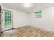 Finished basement with bright walls, window, and door leading to the backyard at 1649 Nw Ezra Church Nw Dr, Atlanta, GA 30314
