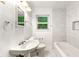 Updated bathroom featuring elegant vanity, tile wall, and soaking tub at 1649 Nw Ezra Church Nw Dr, Atlanta, GA 30314
