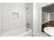 Remodeled bathroom with white tile surround, shower, and sleek fixtures at 1649 Nw Ezra Church Nw Dr, Atlanta, GA 30314