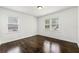 Cozy bedroom with hardwood floors and bright natural light from two windows at 1649 Nw Ezra Church Nw Dr, Atlanta, GA 30314