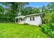 Charming home featuring a welcoming front porch, green lawn, and mature trees creating a serene setting at 1649 Nw Ezra Church Nw Dr, Atlanta, GA 30314