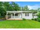 Inviting home with a covered porch, a well-maintained lawn, and lush greenery surrounding the property at 1649 Nw Ezra Church Nw Dr, Atlanta, GA 30314