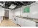 Basement kitchen featuring white appliances and cabinets, marble countertops, and natural light at 1649 Nw Ezra Church Nw Dr, Atlanta, GA 30314