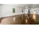 Spacious living room featuring hardwood floors, white walls, and natural light streaming through the windows at 1649 Nw Ezra Church Nw Dr, Atlanta, GA 30314