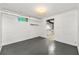 Basement room with painted concrete flooring and an entrance to a kitchen space at 1649 Nw Ezra Church Nw Dr, Atlanta, GA 30314