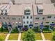 Aerial view of townhomes showcasing the rooflines, walkways, and manicured lawns at 20057 Windalier Way, Roswell, GA 30076