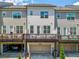 Rear view of townhomes with private decks and garages offering modern living spaces at 20057 Windalier Way, Roswell, GA 30076