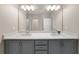 Bathroom with double sink vanity, granite countertops, and a large mirror at 20057 Windalier Way, Roswell, GA 30076