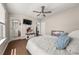 Spacious bedroom featuring a ceiling fan, tv and access to an ensuite bathroom and closet at 20057 Windalier Way, Roswell, GA 30076