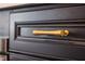 Close-up of a cabinet with a gold bar pull, showcasing the hardware details and dark wood finish at 20057 Windalier Way, Roswell, GA 30076