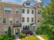 Beautiful townhome exterior with brick facade, manicured landscaping, and inviting entryway, creating curb appeal at 20057 Windalier Way, Roswell, GA 30076