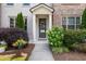 Charming front entrance with decorative door, sidelights, and well-maintained landscaping at 20057 Windalier Way, Roswell, GA 30076