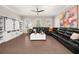 Bright and airy living room featuring a large sectional sofa, built-in shelves with barn doors, and ample natural light at 20057 Windalier Way, Roswell, GA 30076