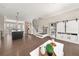 Spacious living room with hardwood floors, recessed lighting, built-in shelving, and stairs leading to the upper level at 20057 Windalier Way, Roswell, GA 30076