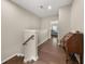 Upstairs hallway with hardwood floors and a view of a bedroom with blue bedding at 20057 Windalier Way, Roswell, GA 30076