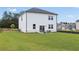 Expansive backyard with lush green grass, patio seating, and a well-maintained exterior of the home at 2655 Mourning Dove Dr (Lot 50), Grayson, GA 30017