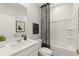 First floor bathroom featuring neutral walls, a tub/shower combo, and modern fixtures at 2655 Mourning Dove Dr (Lot 50), Grayson, GA 30017