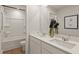 Modern bathroom features a double sink vanity with white countertops and a shower-tub combo at 2655 Mourning Dove Dr (Lot 50), Grayson, GA 30017