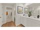 Bathroom with double sink vanity, a walk-in closet and decorative artwork at 2655 Mourning Dove Dr (Lot 50), Grayson, GA 30017