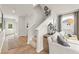 Hallway with stairs leading upstairs, a view of the front door, and a seating area at 2655 Mourning Dove Dr (Lot 50), Grayson, GA 30017
