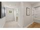 Bright hallway features modern art and leads to a well-lit bathroom and other rooms at 2655 Mourning Dove Dr (Lot 50), Grayson, GA 30017