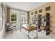 Bright home office featuring neutral paint, a large window, shelving, and a modern desk at 2655 Mourning Dove Dr (Lot 50), Grayson, GA 30017