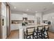 Bright kitchen features stainless steel appliances, granite countertops, and a breakfast bar with modern seating at 2655 Mourning Dove Dr (Lot 50), Grayson, GA 30017