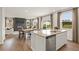 Open concept eat-in kitchen showcasing stainless steel appliances, modern features, and a view into the living room at 2655 Mourning Dove Dr (Lot 50), Grayson, GA 30017