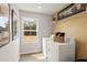 Bright laundry room featuring modern washer/dryer set, shelving, and natural light from a large window at 2655 Mourning Dove Dr (Lot 50), Grayson, GA 30017