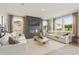 Open-concept living room boasting large windows, neutral walls, modern decor, and a fireplace at 2655 Mourning Dove Dr (Lot 50), Grayson, GA 30017