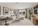 Cozy living room with a sectional sofa, mounted television, and contemporary decorations at 2655 Mourning Dove Dr (Lot 50), Grayson, GA 30017