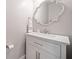 Elegant powder room with a marble countertop, decorative mirror, and white vanity at 432 Providence Walk St, Canton, GA 30114