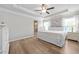 Serene bedroom featuring hardwood floors, tray ceiling, and two windows providing natural light at 432 Providence Walk St, Canton, GA 30114