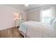 Bedroom featuring an accent wall and wood-style floors at 432 Providence Walk St, Canton, GA 30114