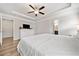 Primary bedroom with a tray ceiling, hardwood floors, and ensuite bathroom entrances at 432 Providence Walk St, Canton, GA 30114