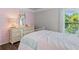 Cozy bedroom with light pink accent wall, wood floors, and dresser at 432 Providence Walk St, Canton, GA 30114