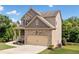 A charming two-story home features a brick and siding exterior with an attached two-car garage at 432 Providence Walk St, Canton, GA 30114