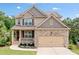 Charming two-story home with a brick and siding exterior, well-manicured lawn, and attached two-car garage at 432 Providence Walk St, Canton, GA 30114