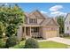 Inviting two-story home with a blend of brick and siding, complemented by a well-kept lawn and cozy front porch at 432 Providence Walk St, Canton, GA 30114